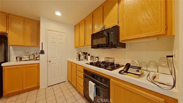a kitchen with stainless steel appliances a stove a sink and a microwave