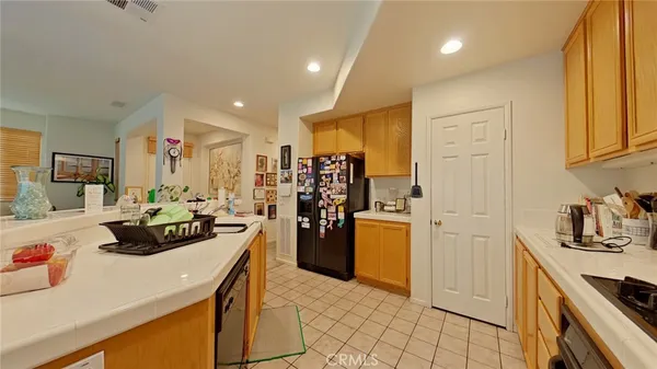 a kitchen with a refrigerator and a sink