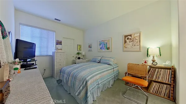 a bedroom with a bed and flat screen tv