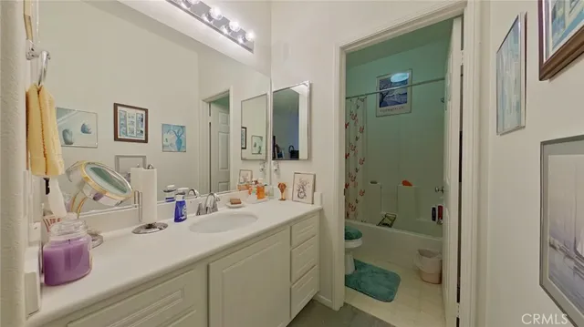 a bathroom with a sink vanity mirror and shower