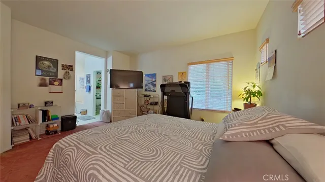 a bedroom with a bed and dresser