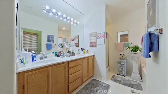 a bathroom with a sink a mirror and a shower