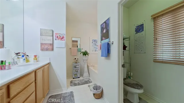 a bathroom with a sink a toilet and shower curtain