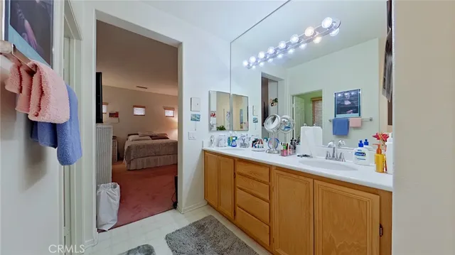 a en suite bathroom with a sink double vanity and a mirror