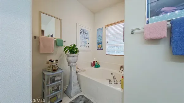 a bathroom with a bathtub a sink and a window