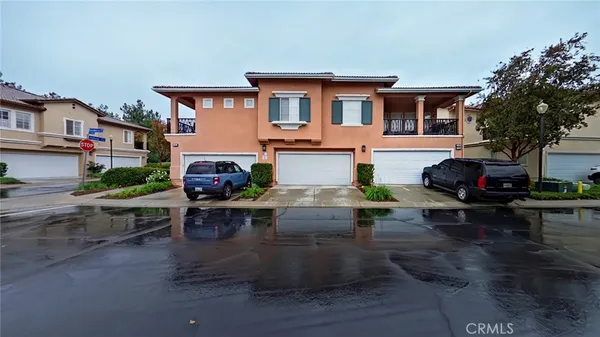 a view of a patio with table and chairs couches under an umbrella