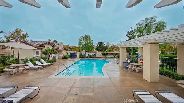 a view of a patio with couches and table and chairs with potted plants