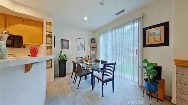 a view of a dining room with furniture and a window