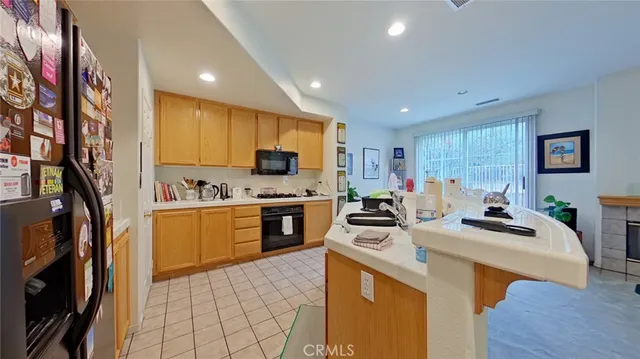 a kitchen with sink a stove and cabinets