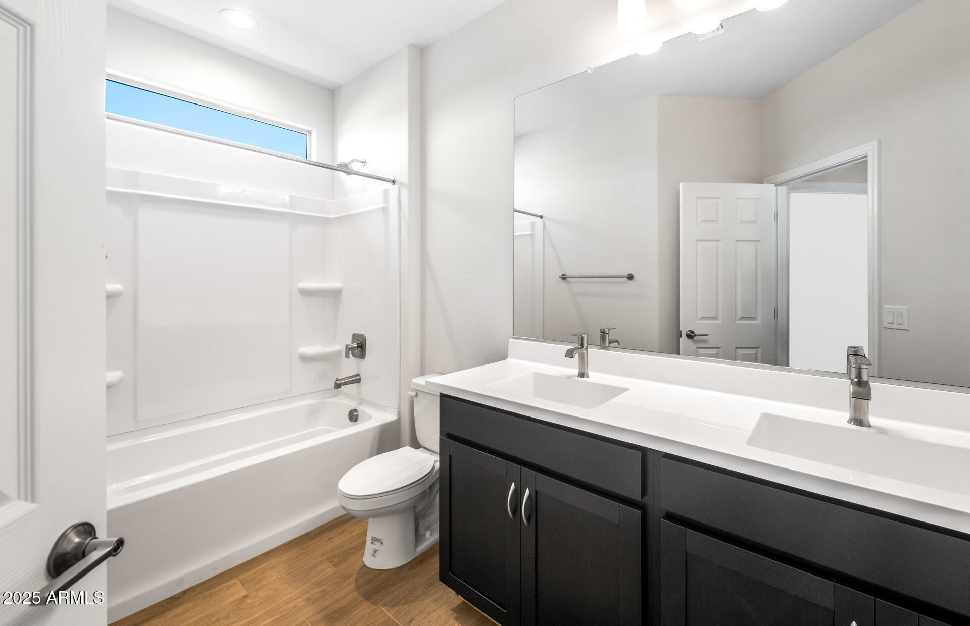 6826 West Ripken Way Florence, AZ 85132 - Photo 13 of 35 a bathroom with a double vanity sink toilet mirror and bathtub