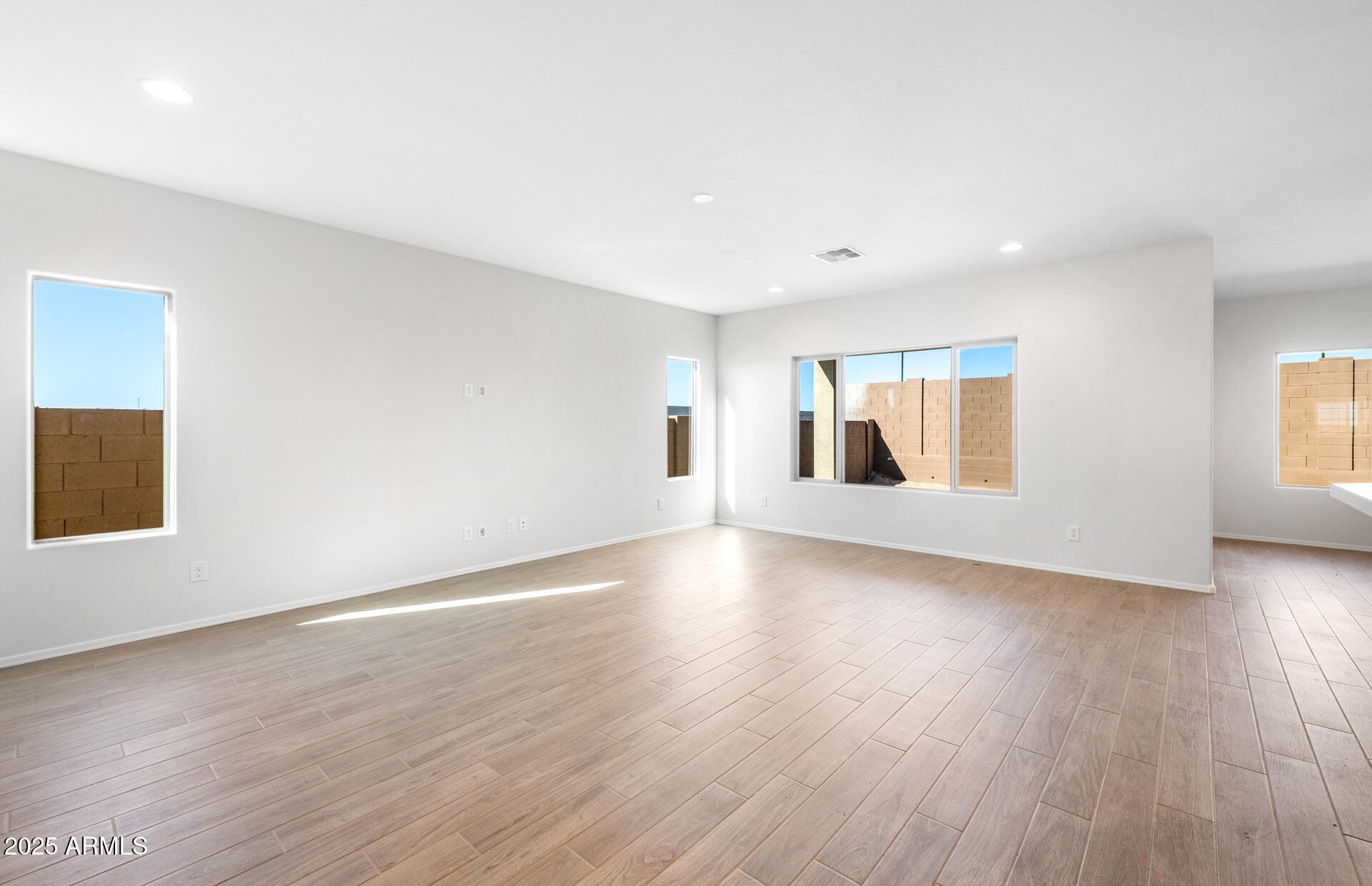 6826 West Ripken Way Florence, AZ 85132 - Photo 15 of 35 a view of empty room with wooden floor and fan