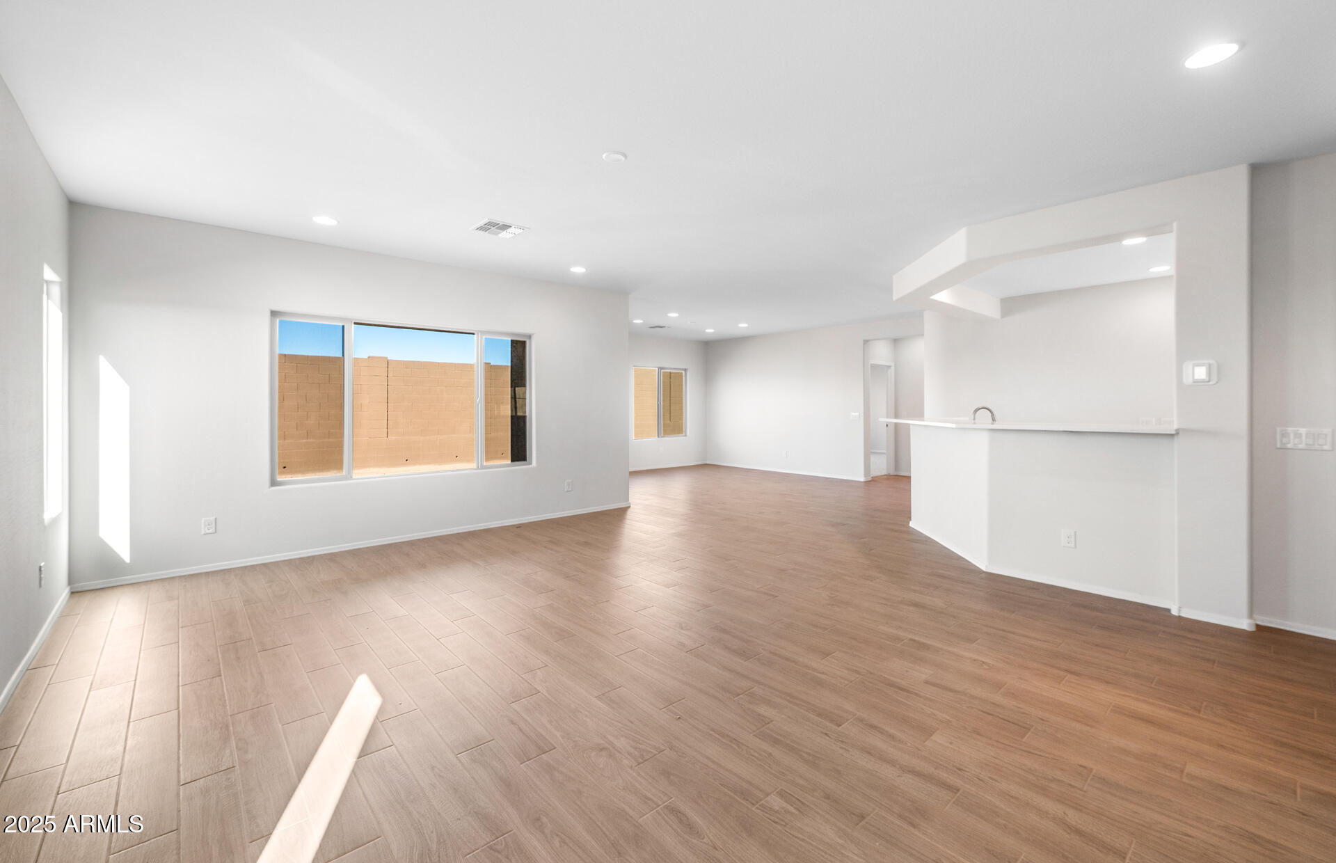 6826 West Ripken Way Florence, AZ 85132 - Photo 16 of 35 a view of an empty room with wooden floor and a window