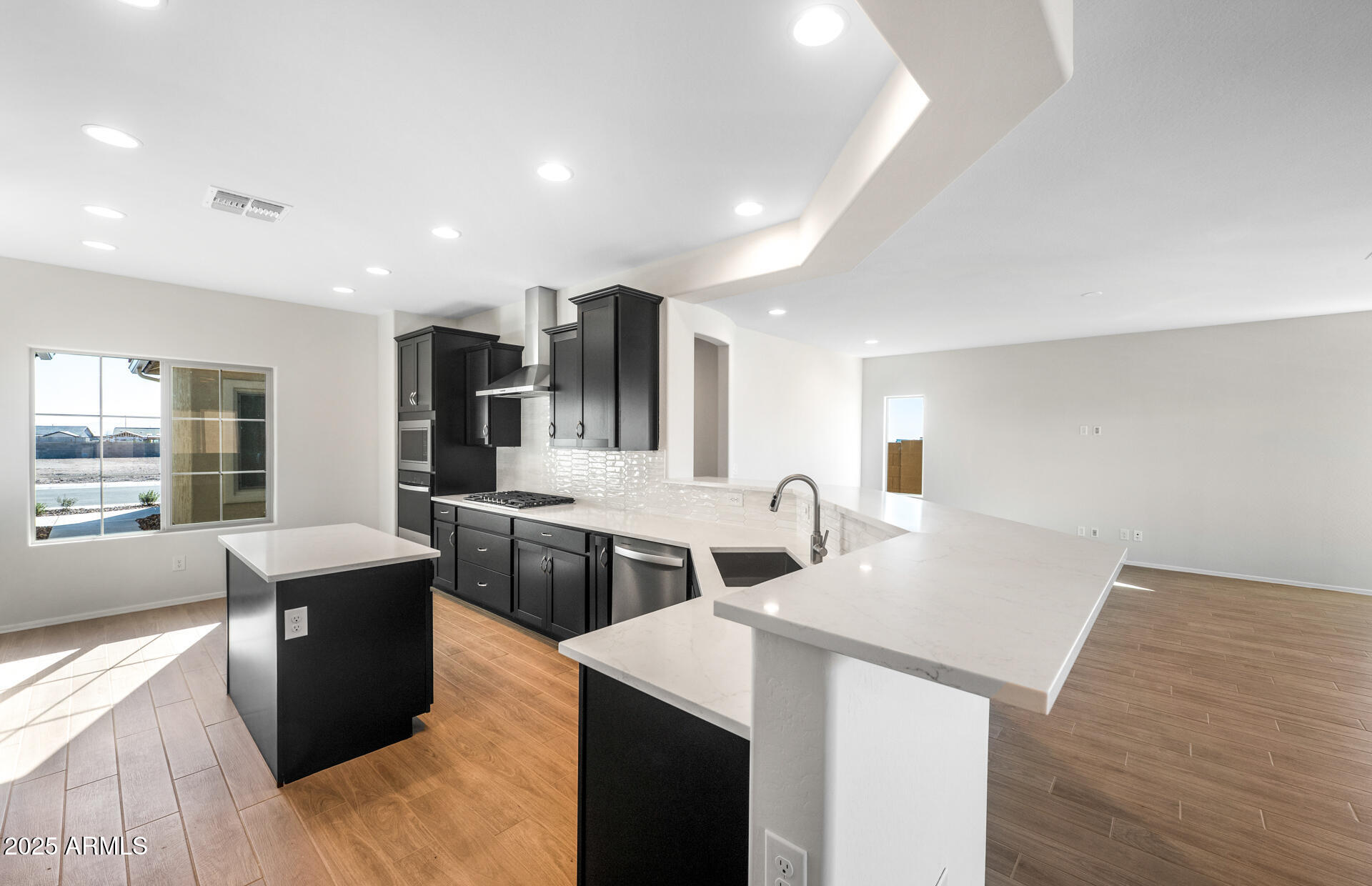6826 West Ripken Way Florence, AZ 85132 - Photo 21 of 35 a kitchen with stainless steel appliances granite countertop a sink stove and refrigerator