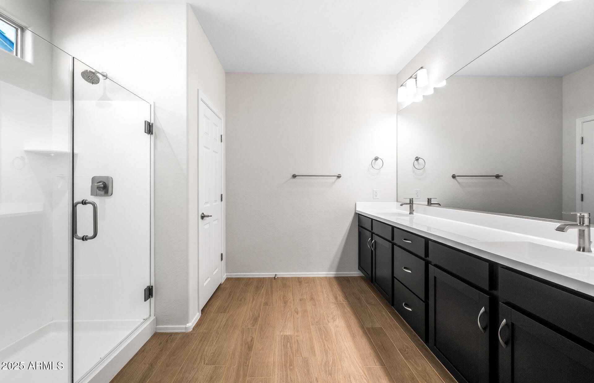 6826 West Ripken Way Florence, AZ 85132 - Photo 31 of 35 a spacious bathroom with a double vanity sink a large mirror and shower