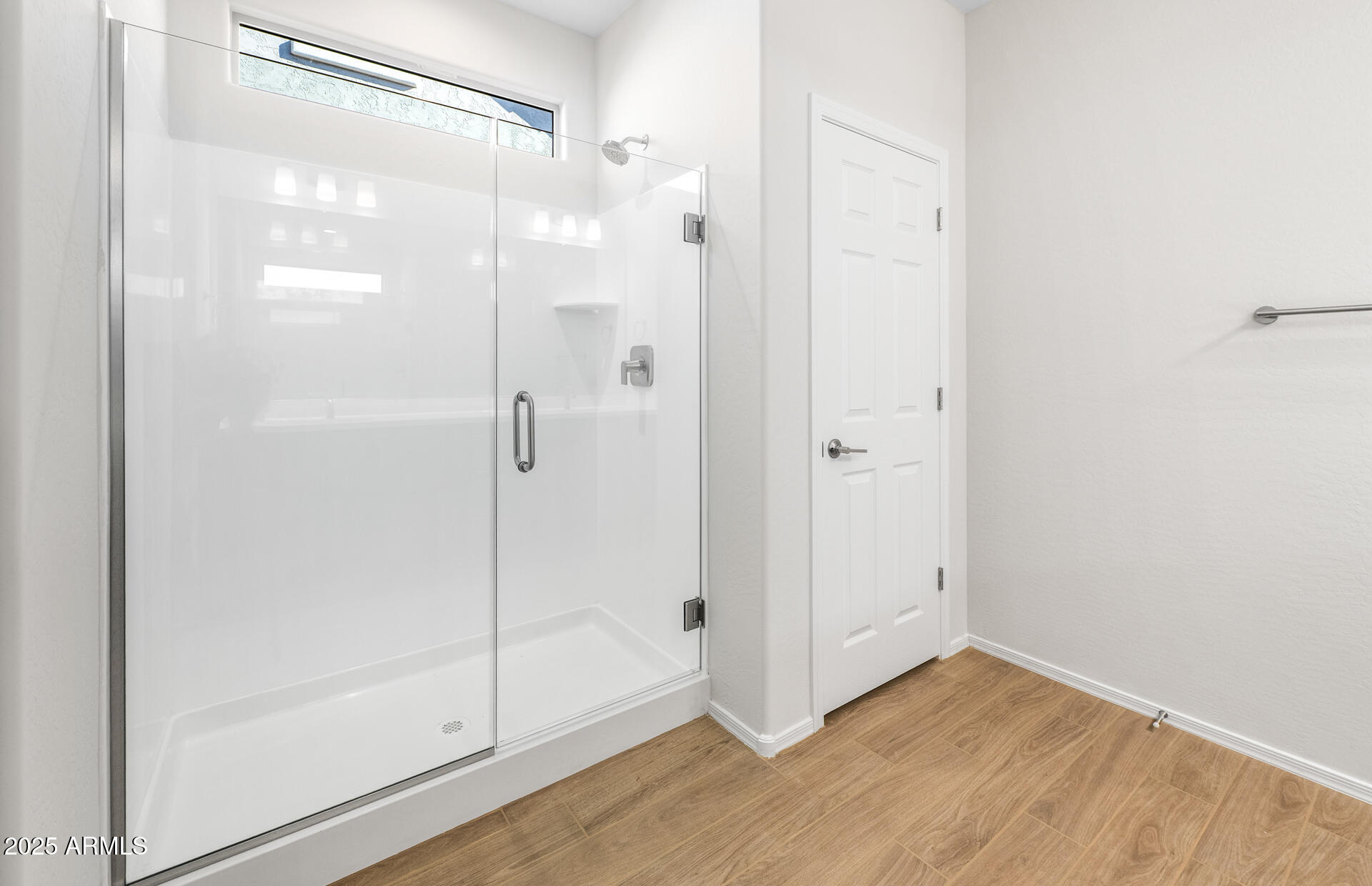 6826 West Ripken Way Florence, AZ 85132 - Photo 32 of 35 a bathroom with a glass shower door