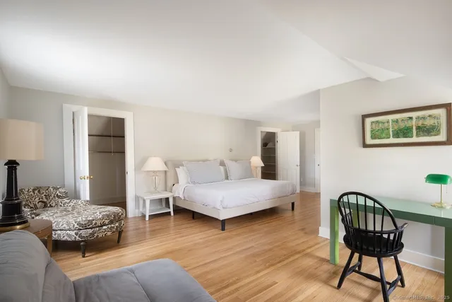 a bedroom with furniture and wooden floor