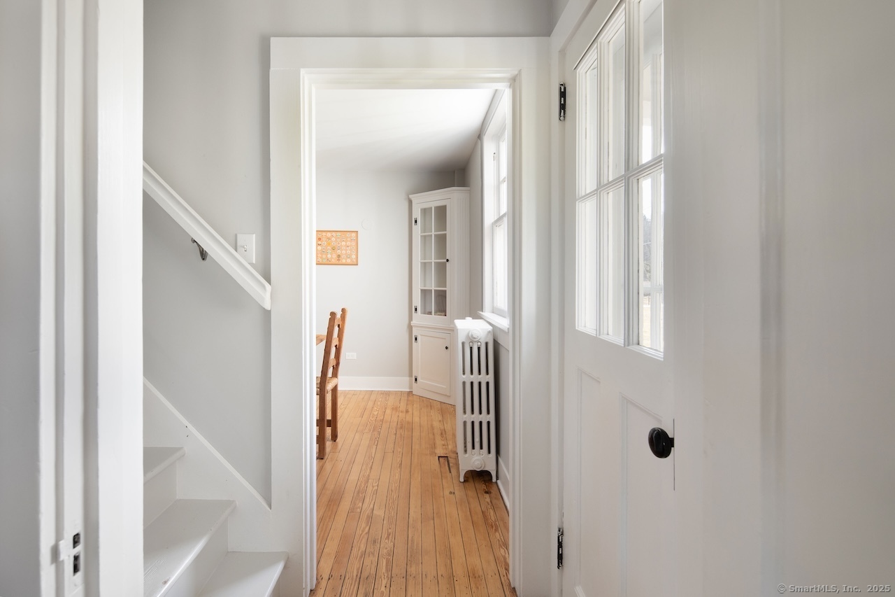 104 Sunset Ridge Road Norfolk, CT 06058 - Photo 8 of 20 a view of a hallway with wooden floor and staircase