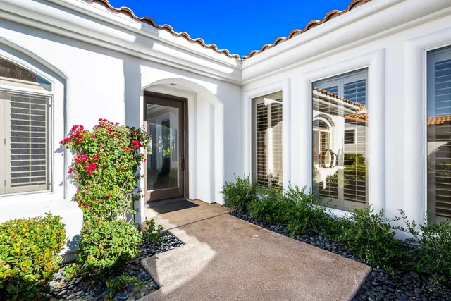 a living room with fireplace furniture and a large window