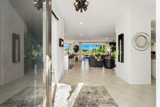 a view of a kitchen with kitchen island and stainless steel appliances