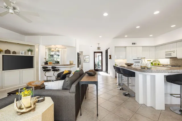 a kitchen with sink and view of living room