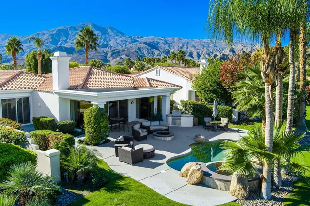 a aerial view of a house with a yard and potted plants