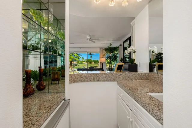 a kitchen with sink refrigerator and large window