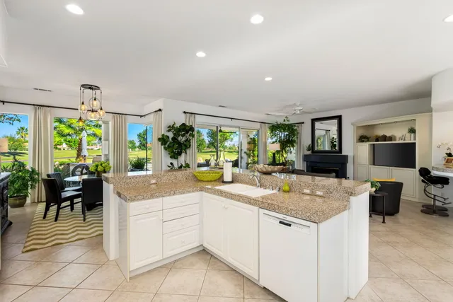 a view of a swimming pool with chairs in a patio