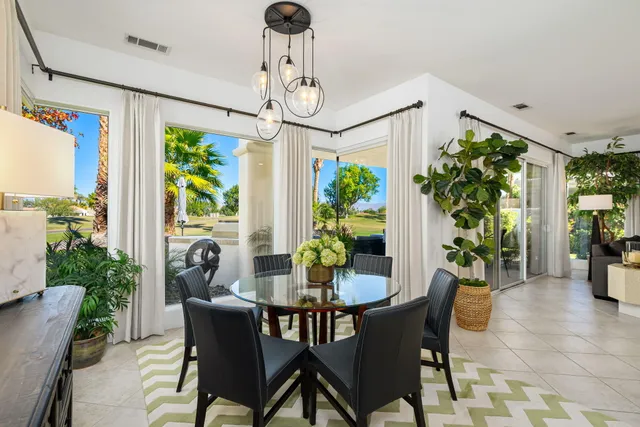 a view of a house with swimming pool and sitting area