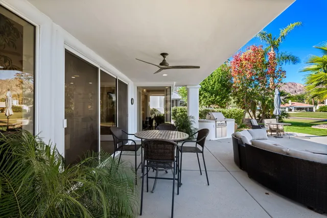 a view of a house with swimming pool and sitting area