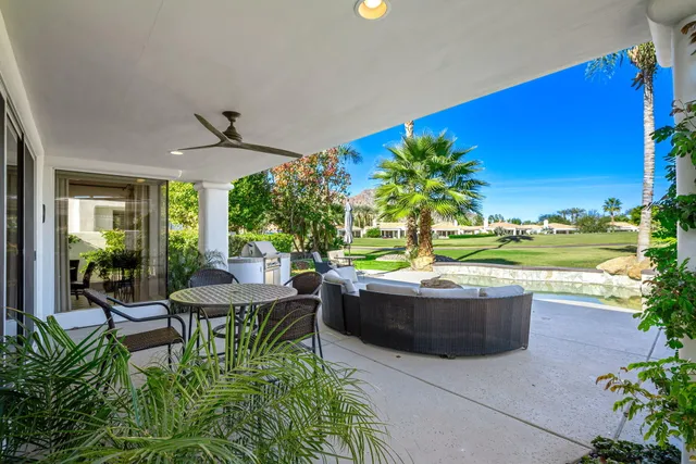 a view of a house with a backyard porch and sitting area