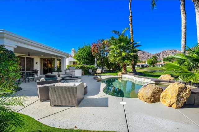 a spacious bedroom with a bed and a chandelier