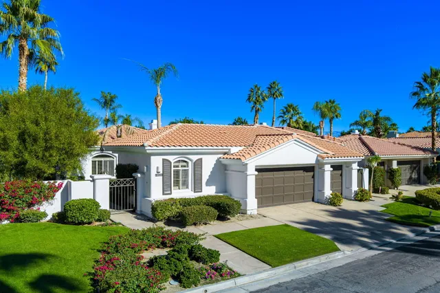 an aerial view of a house with a yard and potted plants