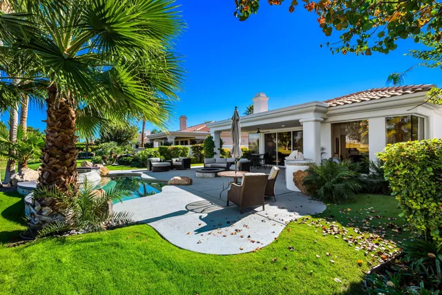 a bathroom with a large tub shower and sink