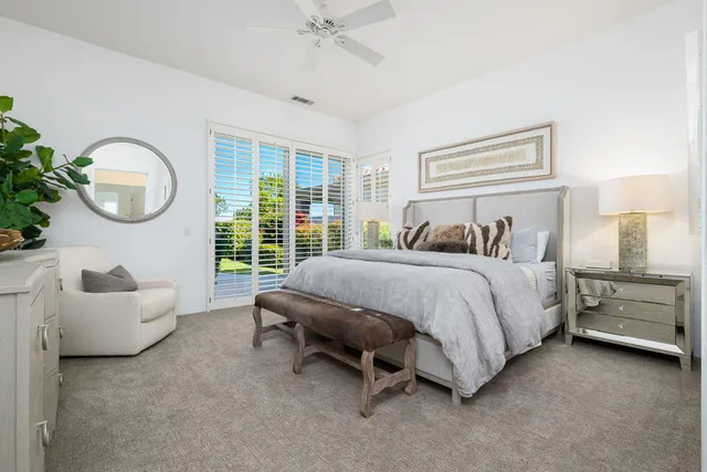 a bedroom with a large bed and a window