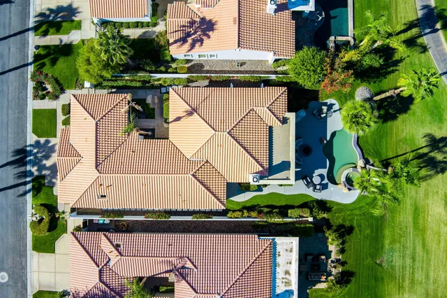 a front view of a house with a yard and flowers