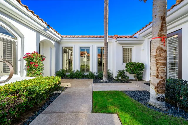 a view of a house with potted plants