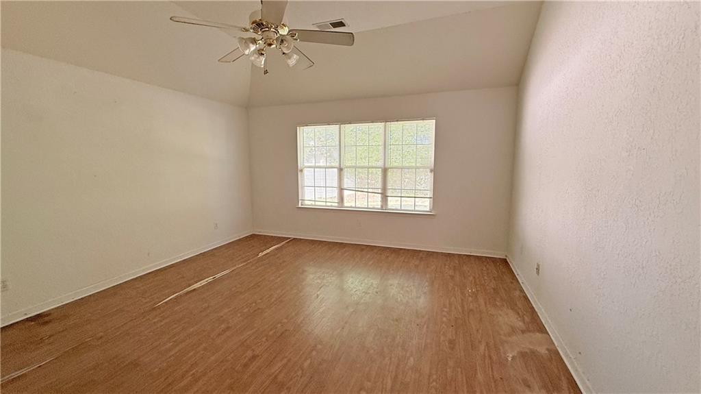 65 Lakeridge Court Covington, GA 30016 - Photo 12 of 17 an empty room with a window and wooden floor