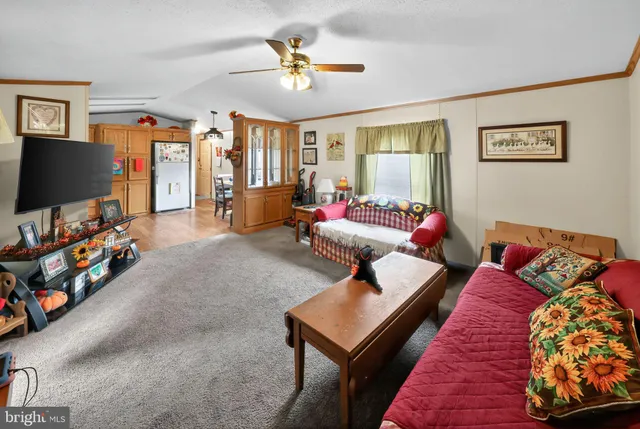 a kitchen with stainless steel appliances granite countertop a refrigerator stove top oven and sink with wooden floor