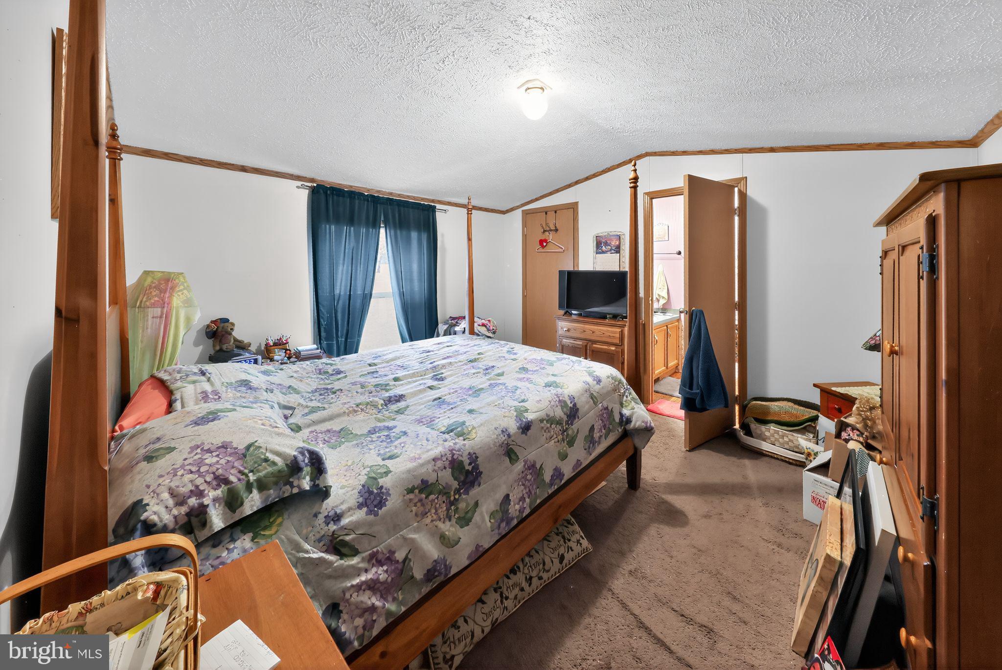 8 Penney Lane Coatesville, PA 19320 - Photo 7 of 14 a bed sitting in a bedroom next to a window