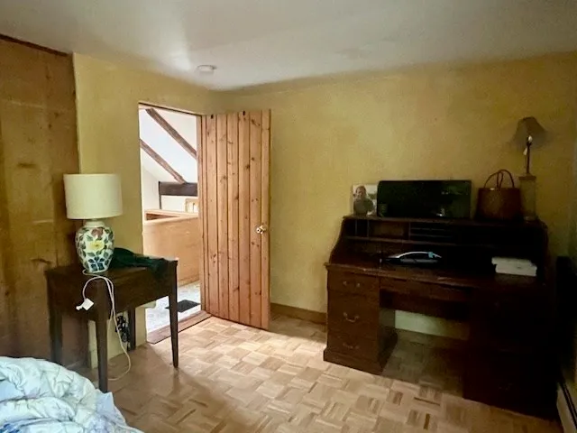 a view of green field with trees in the background