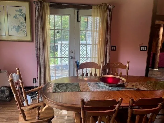 a kitchen with stainless steel appliances granite countertop wooden cabinets a stove a sink and dishwasher with wooden floor