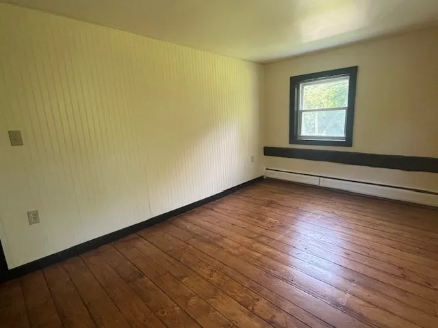 a view of a grassy field with trees