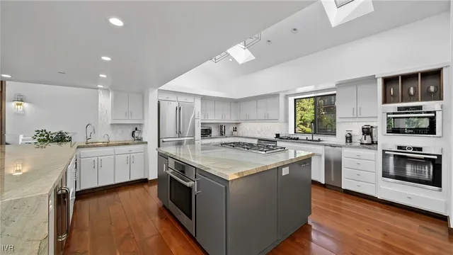 a kitchen with stove a sink and refrigerator