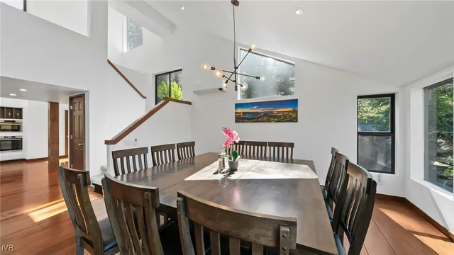 a view of a dining room with furniture wooden floor and chandelier