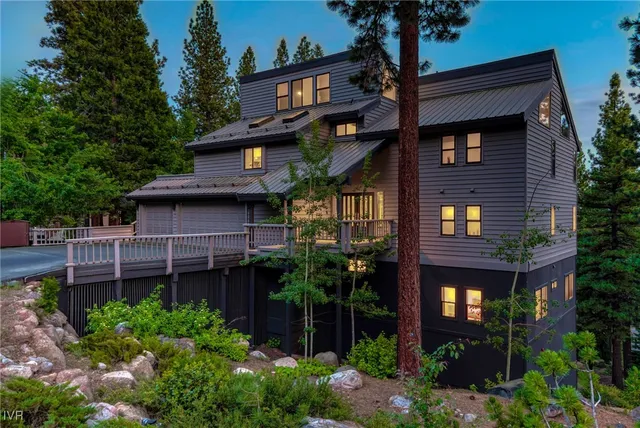 a view of a house with brick walls and plants