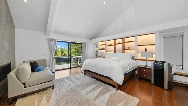 a bedroom with a bed and a large window