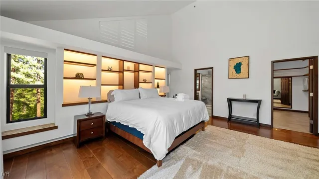 a spacious bedroom with a large bed and a large window