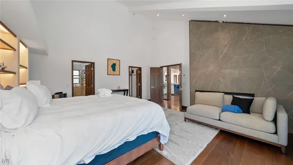 a bedroom with a bed couch and window