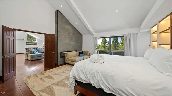 a bedroom with a bed couch and a large window