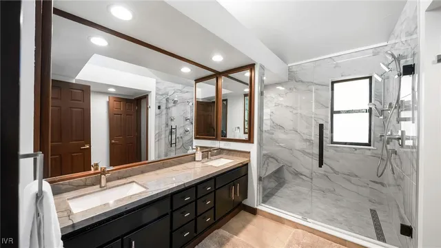 a bathroom with a granite countertop sink mirror and double